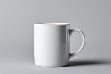 Clean white mug sitting on a surface casting shadow
