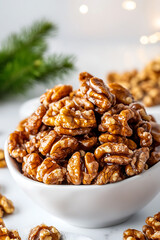 Obraz premium A bowl overflowing with caramelized walnuts, glistening with a sugary coating, evokes a festive, holiday treat. A seasonal snack.