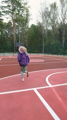Obraz premium Running girl preparing for competition, race or marathon. Motivation, training for health and well-being on city streets, parks or roads. Sports, exercise, training and energy.