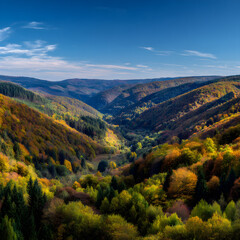 Fototapeta premium Vibrant Autumn Landscape with Rolling Hills and Colorful Foliage Under Bright Blue Sky