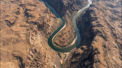 Aerial view of a meandering river in a desert canyon