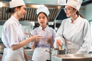 Cooking Class in Commercial Kitchen , Diverse Culinary Student Receives Hands-On Training from Head...