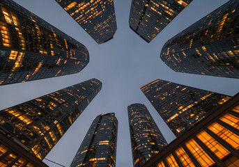 Architectural marvels of a modern city, illuminated from within at twilight, creating a captivating urban vista