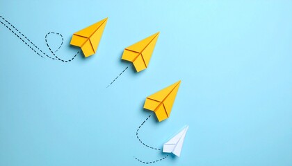 White paper airplane diverging from yellow formation on blue background with dashed paths, symbolizing individuality and bold direction