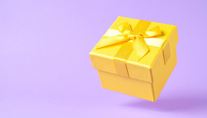 Small yellow gift box with bow floating over pastel purple background. Minimal present.