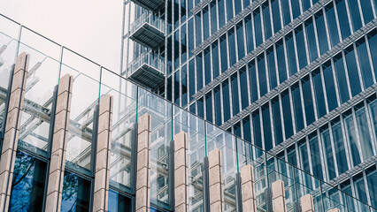 Glass buildings and geometric shapes in modern blue architecture background..