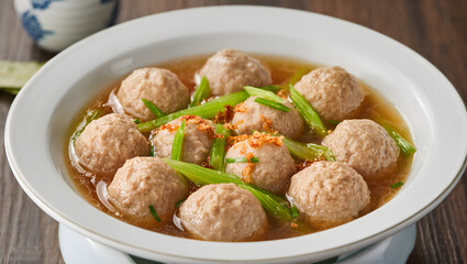 Bakso meatballs close-up in a rich broth with fresh green celery and fried shallots, high-resolution, appetizing and vibrant, food magazine style