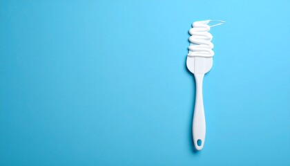 White Spatula With Whipped Cream On Light Blue Background
