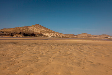 The view of volcanic hilly landscape of Sotavento beach in Fuerteventura island