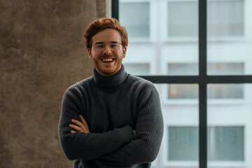 Smiling man with red hair and glasses happy
