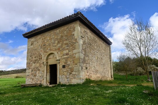 Romanesque hermitage of San Pelayo surrounded by green fields in Olmos de Ojeda