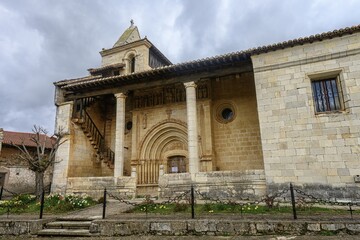 Facade of the Church of the Transfiguration with Romanesque portal and tower in Palencia
