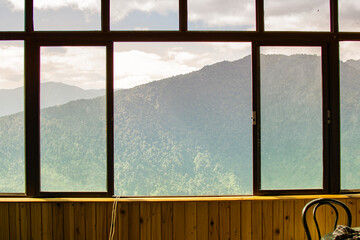 Window with beautiful view of Himalayan mountains outside. Homestay at Sikkim, West Bengal, India.