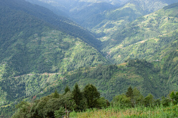 Fototapeta premium Sun rays falling on Himalayan mountain range, scenic beauty of layers of mountains, Okhrey, sikkim, India. Okhrey village a remote place in Sikkim where mountain range view is enjoyed by tourists.