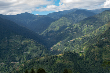 Fototapeta premium Sun rays falling on Himalayan mountain range, scenic beauty of layers of mountains, Okhrey, sikkim, India. Okhrey village a remote place in Sikkim where mountain range view is enjoyed by tourists.