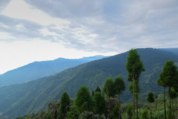 Naklejka premium Scenic beauty of layers of mountains, Okhrey, sikkim, India. Okhrey village of one of the remotest places in Sikkim where peaceful, tranquil Himalayan mountain range is enjoyed by tourists from India.
