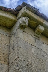 Stone corbel under tiled roof of Romanesque Church in Pison de Castrejon © Agustin