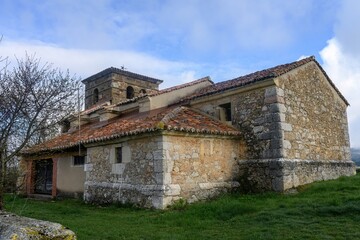 Fototapeta premium Church of San Juan Evangelista in Intorcisa with stone bell tower and tiled roof