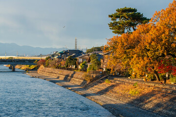 Uji riverside village by Uji-gawa river in autumn at sunset, Kyoto