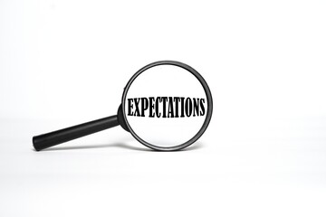 the word EXPECTATIONS on the magnifying glass. magnifying glass concept on white background.