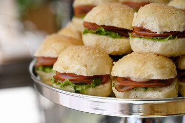 sandwich on a plate, sandwich with ham,  ham and lettuce mini sandwiches, elegant silver tray appetizers, delicious party sliders display