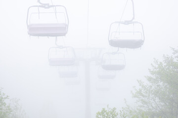 An empty, non-working cable car on a foggy day
