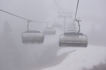 An empty cable car on a foggy day