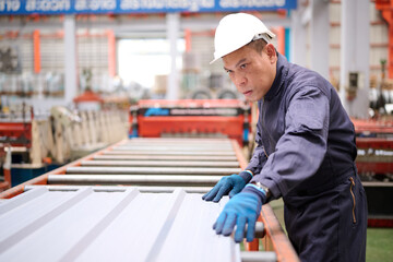 Technician or worker checking metal sheet in the factory