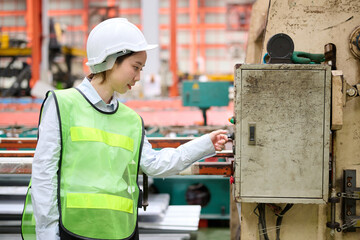 Engineer or worker working at machine control panel and push a button in the factory