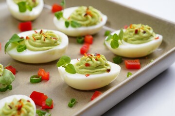 Deliciously prepared deviled eggs with green filling and garnish