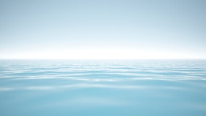 Obraz premium Serene blue ocean surface with gentle ripples extending to a soft, hazy horizon line under a clear sky