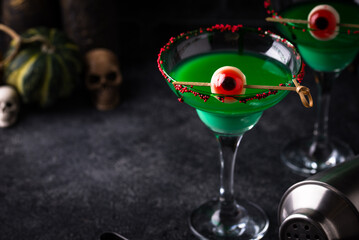 Spooky green halloween cocktail with eyeballs
