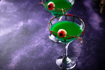 Spooky green halloween cocktail with eyeballs
