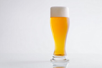 a glass of beer sitting on a table