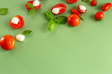 bright vegetables and white cheese on green background