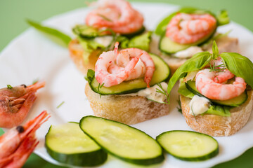 Gourmet appetizer with shrimps, greens and cucumbers for a buffet