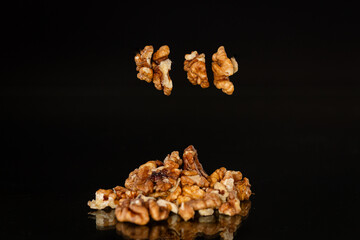 delicious peeled walnuts on a black background