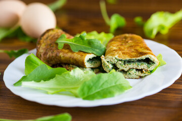 Breakfast with omelette, salad and fresh green herbs