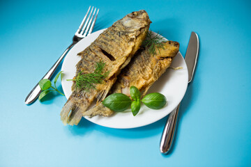 Homemade dish - golden crucian carp on a plate with spices