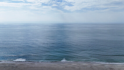 sea waves beach coast drone aerial blue sky background nobody