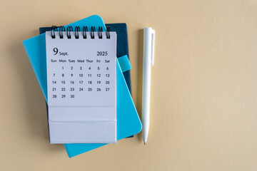 Hello, September 2025. Desktop calendar and notepad for writing on the desktop.