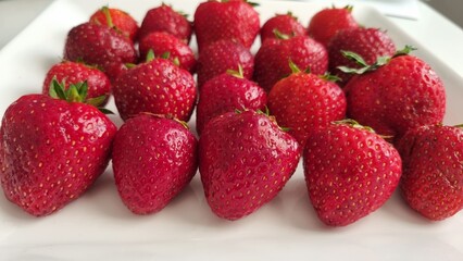 strawberries in a bowl. White ceramic fruit vase containing red strawberries, healthy eating concept. strawberries in a bowl. Top view.