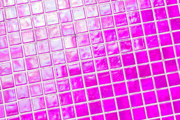 Mosaic of scratched glass tiles as a decorative element in architecture. Antique square pink tiles.