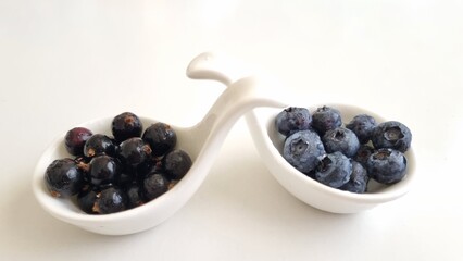 Mixed berries in white fruit, blueberry, blackcurrants in bowls. Healthy eating concept. Top view. Collection of berries in white bowls, isolated on white background 