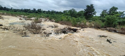 flooded river flowing throughout the rocks