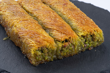 Delicious Turkish dessert pistachio kadayif. Burma kadayif on white background