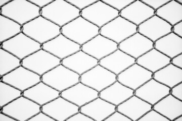 Fototapeta premium Black and White Close-Up of a Wire Mesh Fence Structure