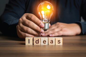 Sparkling Light Bulb Being Touched – New Idea and Creativity Symbol