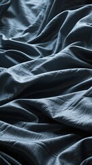 Fototapeta premium Close-up of Crumpled Dark Fabric with Soft Textures