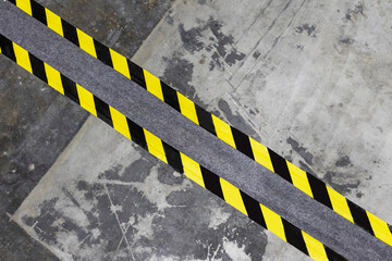 Concrete wall with yellow and black warning stickers